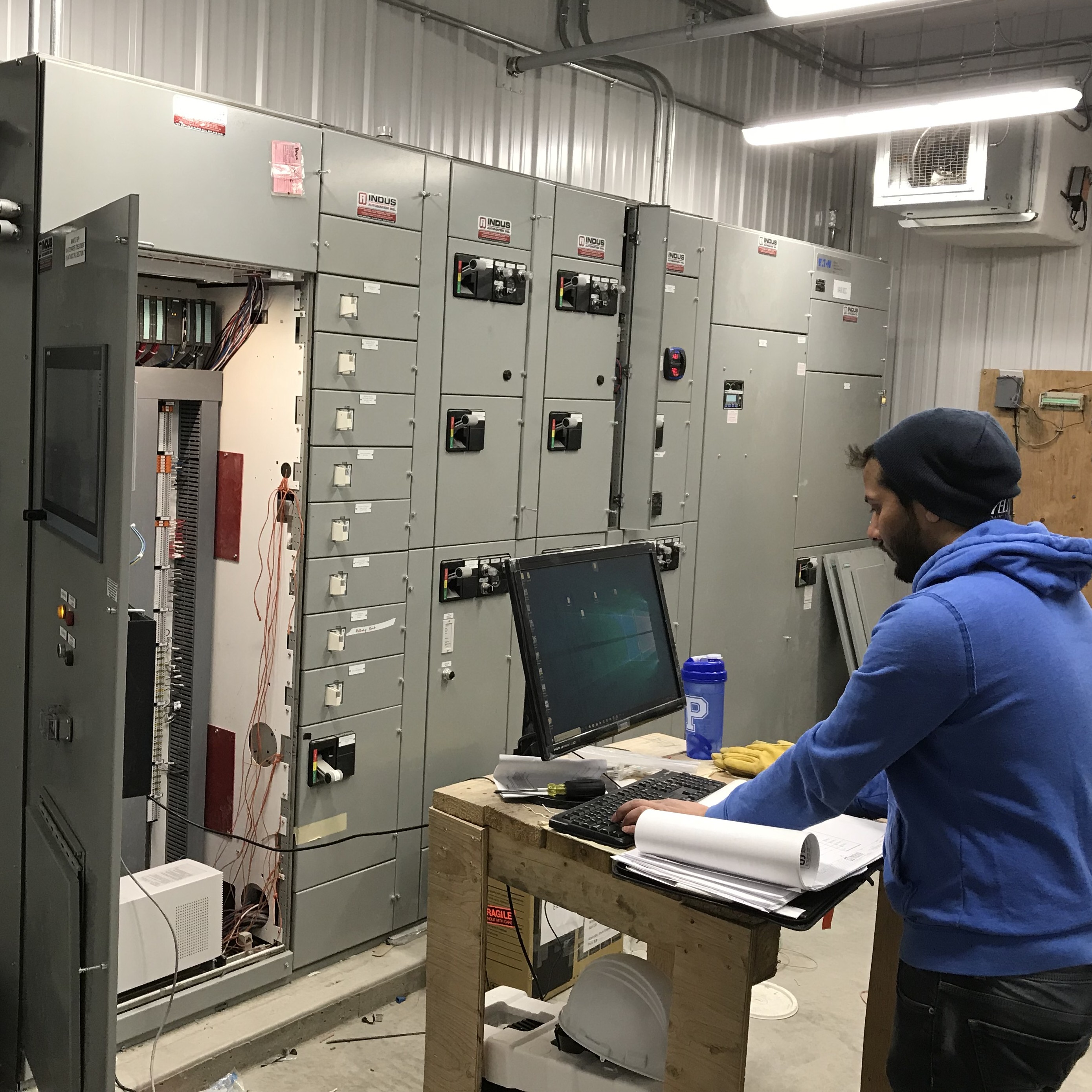 Indus Automation technician commissioning an industrial control system on-site