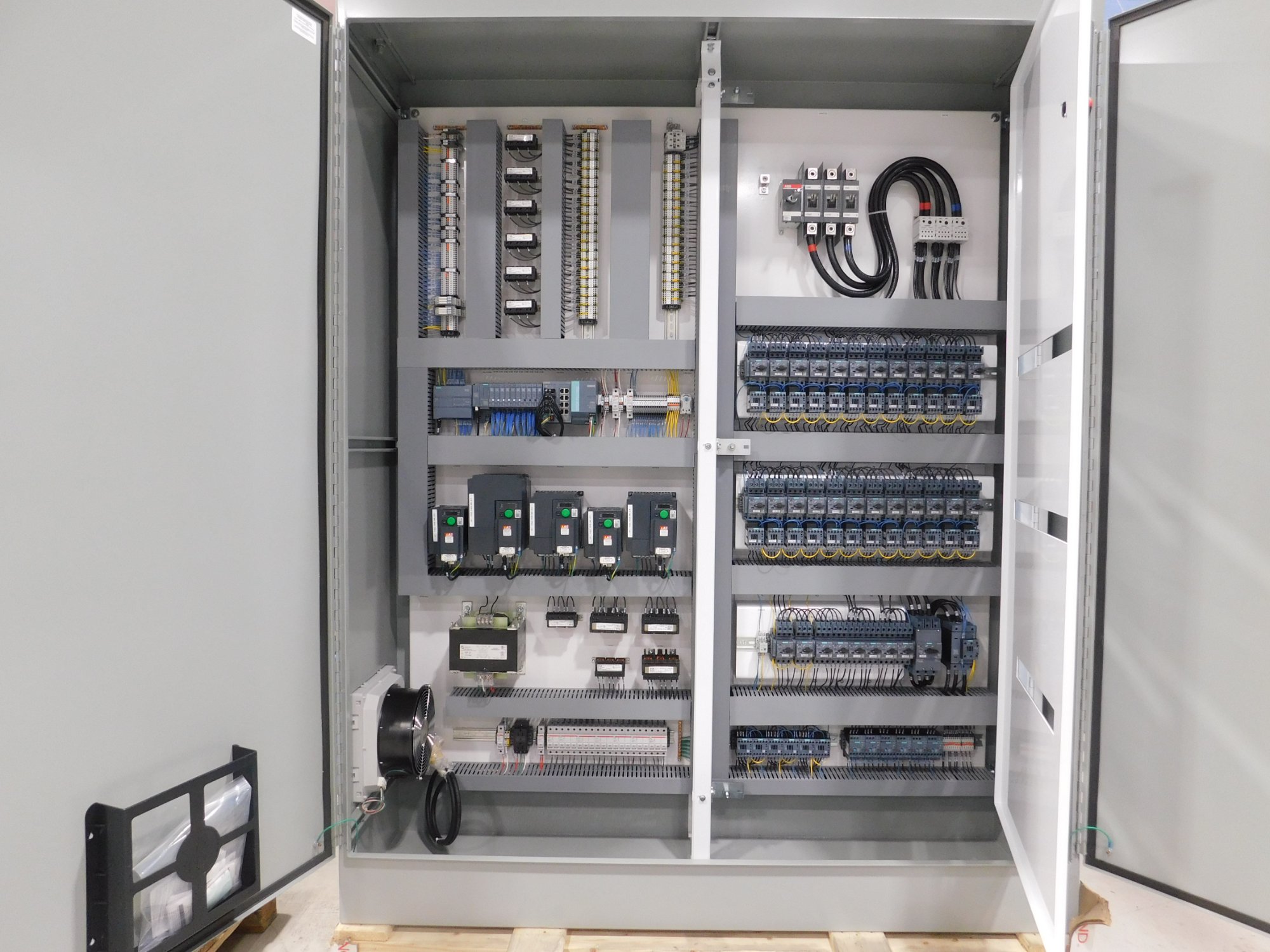 Custom control panel interior with VFDs and PLC modules - Indus Automation