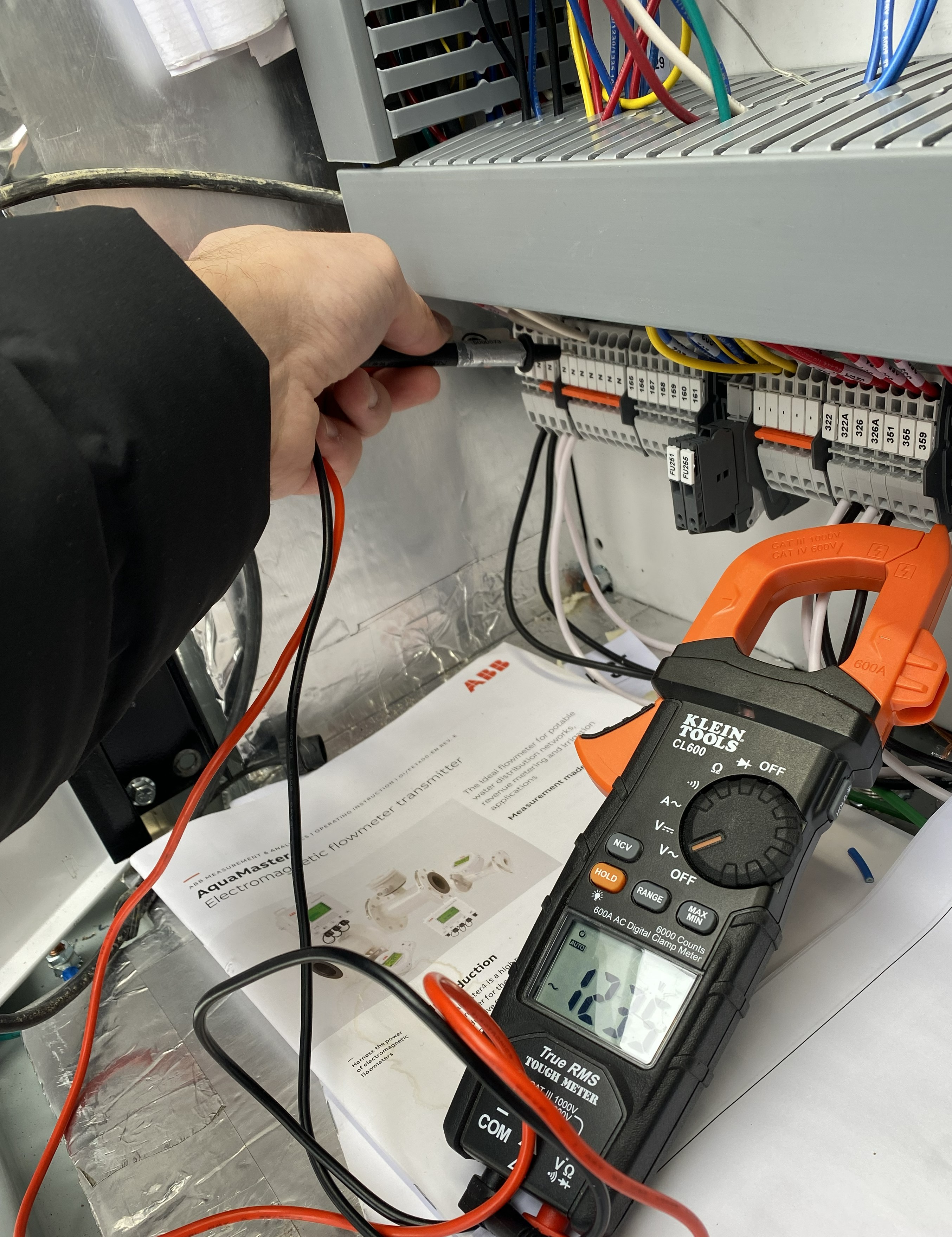 Technician performing diagnostics on industrial control system - Indus Automation